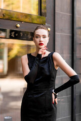 Young female model in black dress in Breakfast at Tiffany's style