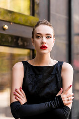 Young female model in black dress in Breakfast at Tiffany's style