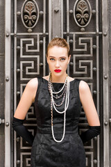 Young female model in black dress in Breakfast at Tiffany's style