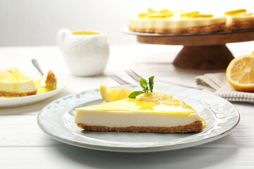 Delicious cheesecake with lemon curd served on white wooden table, closeup