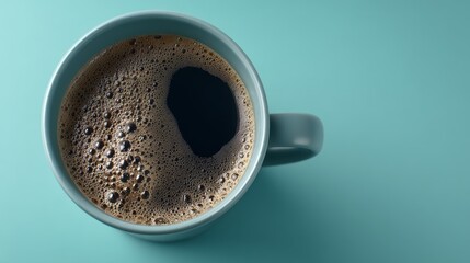 Close-up view of a steaming mug filled with dark coffee, topped with creamy foam, set against a smooth pastel backdrop emphasizing texture and contrast