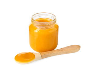Baby food. Tasty puree in glass jar and spoon isolated on white