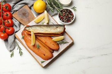 Smoked herrings, spices and tomatoes on white marble table, flat lay. Space for text