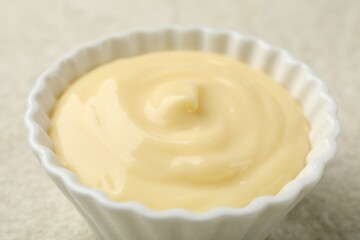Tasty vanilla pudding on light textured table, closeup