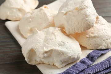 Delicious homemade meringue cookies on wooden table, closeup