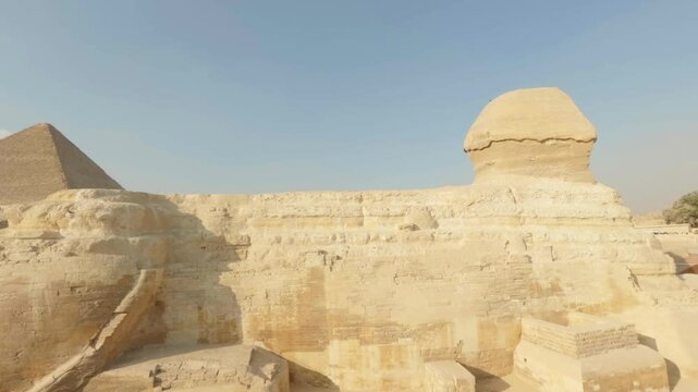Great sphinx of giza and pyramid of khafre under clear blue sky