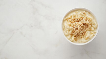 A creamy bowl of macaroni and cheese topped with breadcrumbs. Featuring comfort and richness