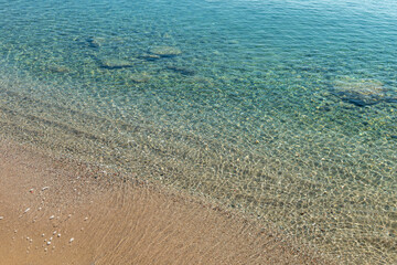 Pebble coast and waves in Datca, Turkey.  Clear water of the Mediterranean coast of Turkey.