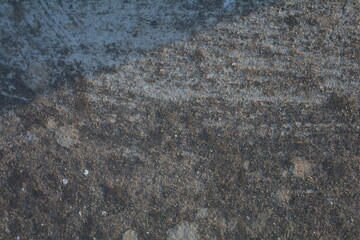 Unique textures of natural rock surface reflecting light during late afternoon hours in a serene outdoor setting