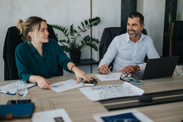 A multicultural group of business people engage in a lively discussion around a conference table, emphasizing teamwork and collaboration in a modern corporate environment.