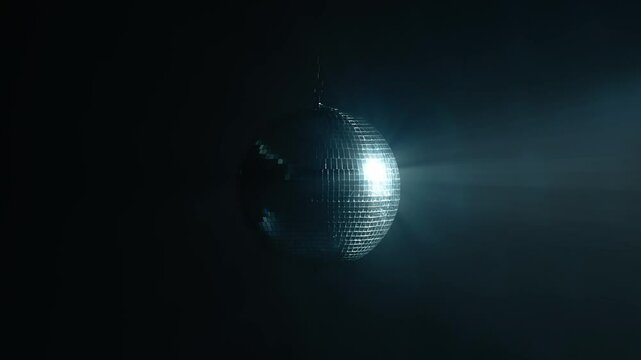 Disco mirror ball illuminates the background of a nightclub. A party is illuminated by a disco ball. Party and celebration concept.