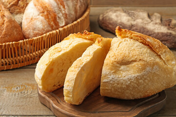 Slices of fresh bread on wooden table, closeup