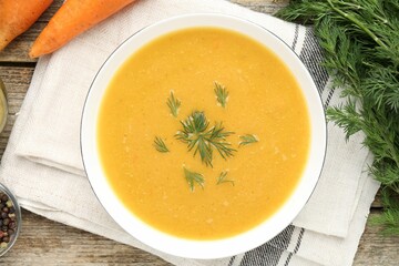 Delicious lentil cream soup with dill served on wooden table, flat lay