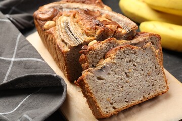 Cut banana bread with nuts on table, closeup