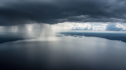 Obraz premium Aerial view of rain clouds over a lake. Possible use Stock photo for nature, weather, travel