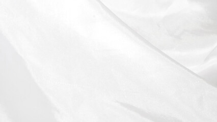 Shiny white silk fabric reflecting soft light, creating a rich texture