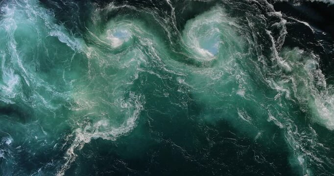 Blue waves of water of the river and the sea meet each other during high tide and low tide.