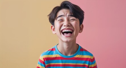Caucasian teen boy on colorful plain bright background happy laughing hysterical looking at camera portrait banner with copy space ad concept marketing