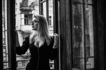 Obraz premium Portrait of nice romantic woman in black midi dress. Clothes mix style. Middle aged lady, fashion concept 