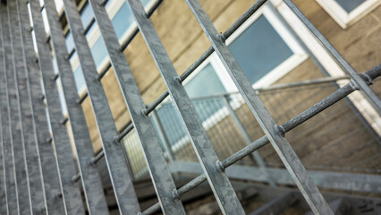 Galvanized steel railing protecting building access with blurred background