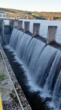 A full reservoir discharges water at full speed into the river. The Yeguas Reservoir is located between C&oacute;rdoba and Ja&eacute;n, in southern Spain.