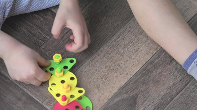 Children are actively engaged in imaginative play and skill development through vibrant and colorful building blocks
