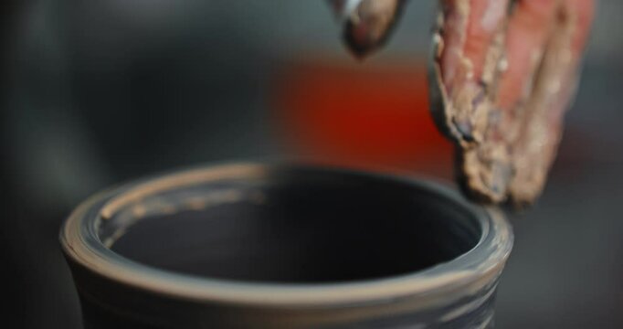 Mastering pottery techniques in a ceramic studio with hands shaping clay into art