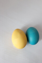 Easter eggs in yellow and blue, decorated with patriotic symbols such as the Ukrainian trident, a tractor, and the map of Ukraine. The designs prominently feature the national colors of Ukraine 
