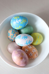 Colorful Easter eggs with hand-painted floral patterns on a light background. Spring atmosphere, festive decoration, and Easter traditions.