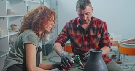 Crafting pottery with skilled artisans in a studio setting during a creative workshop session