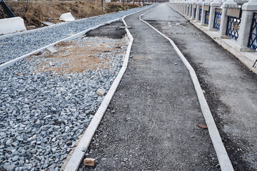 There is a road that features a distinctly marked white line running down the center, with a layer...