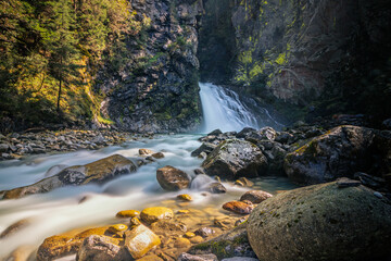 waterfall long exposure river flow good light in the alps