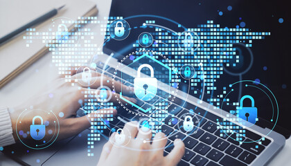 Cybersecurity concept with person typing on laptop and digital padlock symbols overlayed on tech...