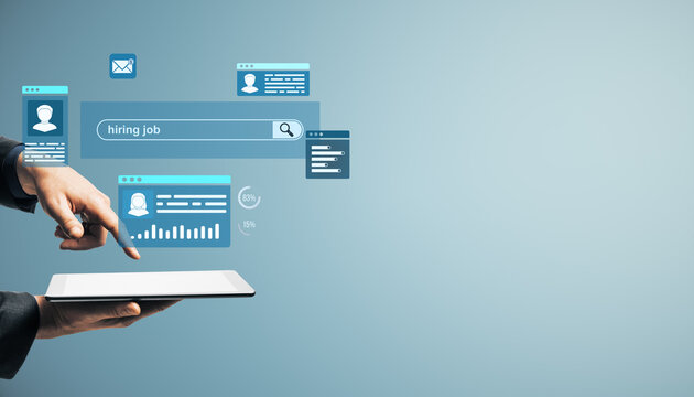Businessperson using tablet to search for hiring job candidates with digital interface on light blue background representing recruitment technology concept.