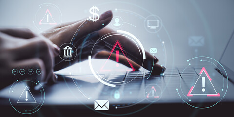 Person typing on laptop with warning icons and digital financial elements over light background, highlighting cybersecurity business concept.