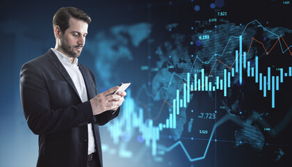 Businessman using smartphone with digital stock market graph overlay on futuristic blue background in financial technology concept scene.