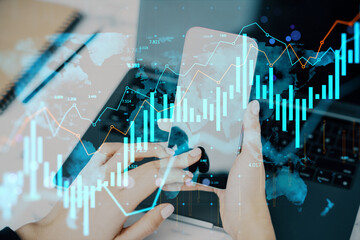 Businessperson analyzing financial data charts on smartphone with abstract global technology overlay on light office background concept.