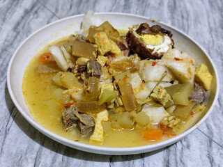 Ketupat Lebaran. Chicken vegetable ketupat is a typical Indonesian dish that is famous for its deliciousness and has a special place in Indonesian culinary culture