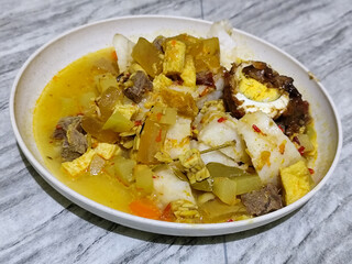 Ketupat Lebaran. Chicken vegetable ketupat is a typical Indonesian dish that is famous for its deliciousness and has a special place in Indonesian culinary culture