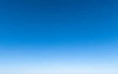 Vibrant blue sky gradient showcasing a seamless transition from light to deep blue, perfect for...