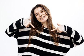 Young brunette with smile, pointing at herself with fingers on white background. Concept of...