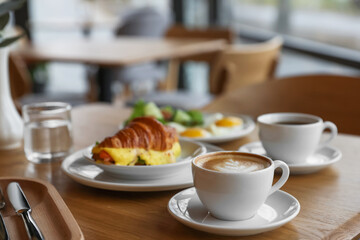 Delicious breakfast served on wooden table in cafe