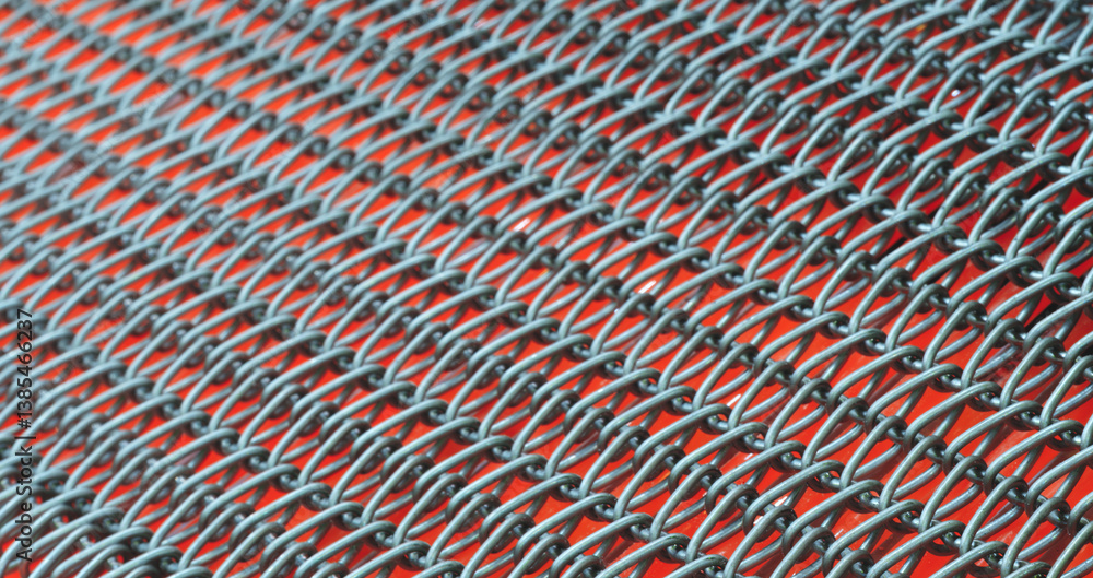 Poster a close up of a chain link fence with a red background. the fence is made of metal and has a lot of 