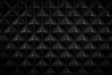 Dark black textured background of patterned wall. The pattern consists of squares and rectangles.