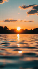 Naklejka premium Sunset Reflection: The sun descends, painting the sky with vibrant hues and casting a warm, golden glow on the serene water's surface, offering a moment of peace.