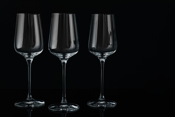 Three empty clean glasses on black background