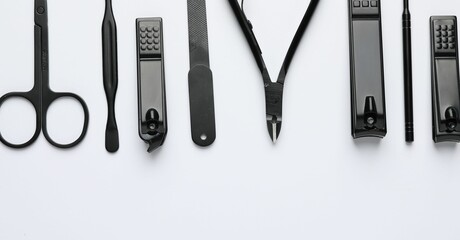 Set of different manicure tools on white background, flat lay. Space for text