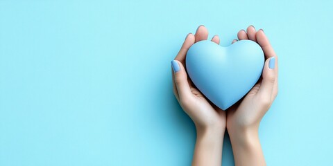 Obraz premium Gentle and caring hands cupping a smooth light blue heart, perfect for health campaigns, Mother's Day, or World Heart Day messaging, emphasizing compassion and wellness.