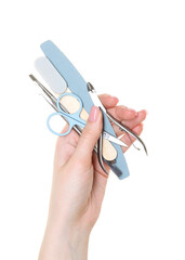 Woman with manicure tools on white background, closeup