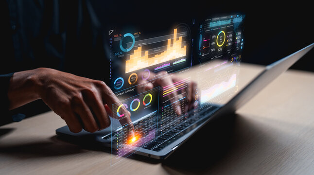 A digital interface shows data visualizations and analytics being interacted with on a laptop, highlighting technology and data analysis.